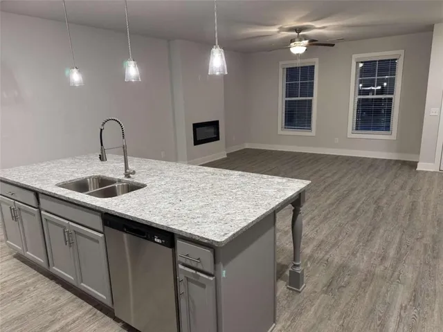 a kitchen with a sink a vanity and chandelier