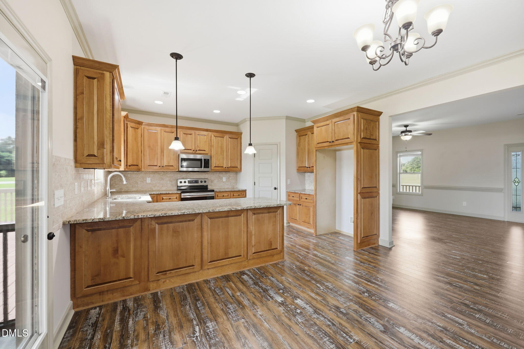 3587 Hannah Creek Road Benson, NC 27504 - Photo 9 of 43 a kitchen with stainless steel appliances granite countertop a sink a stove and a wooden floors