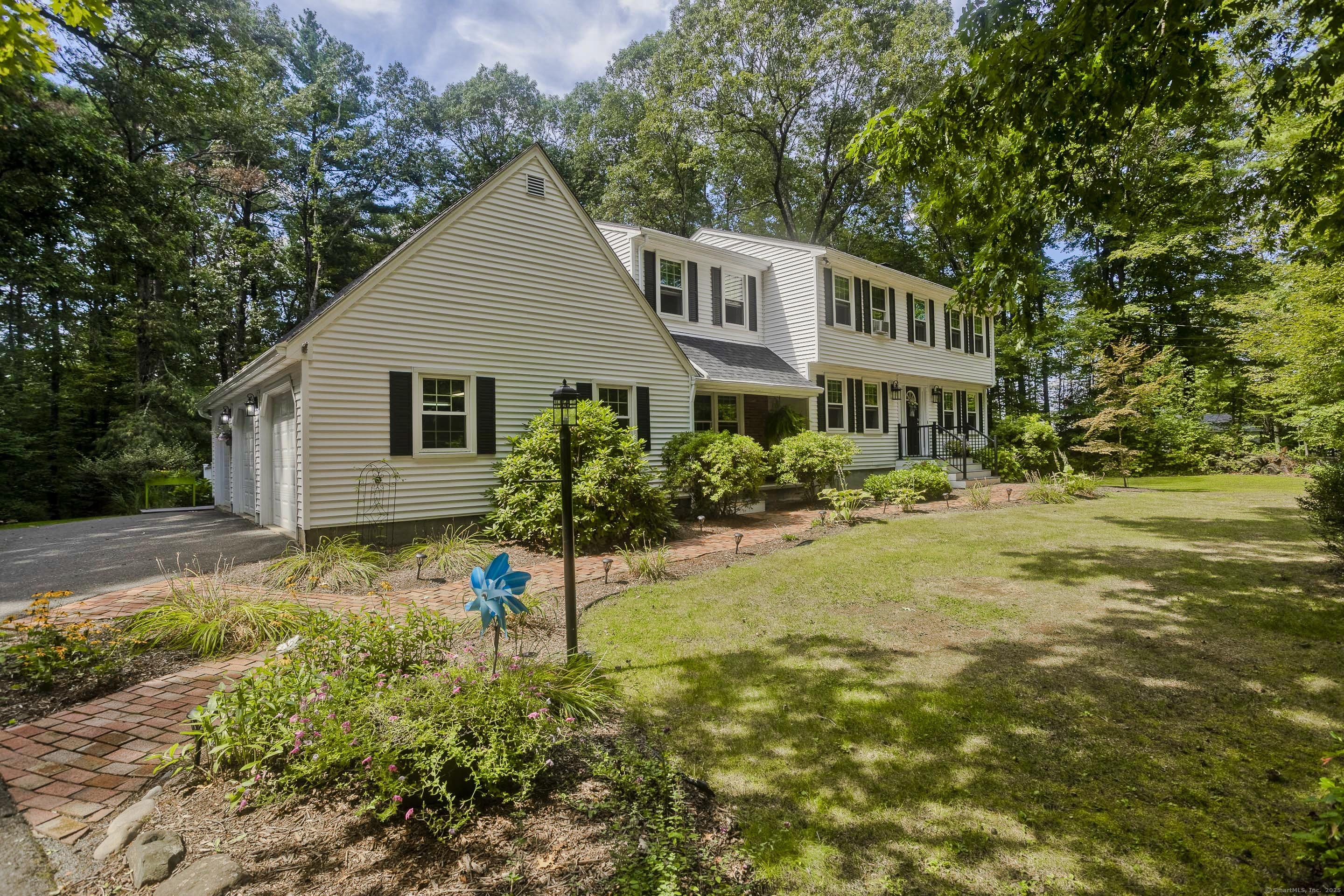 a view of a house with pool and sitting area