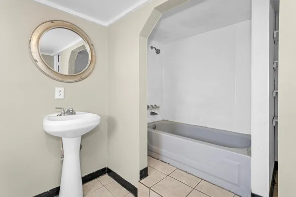 a bathroom with a sink a bathtub and a mirror