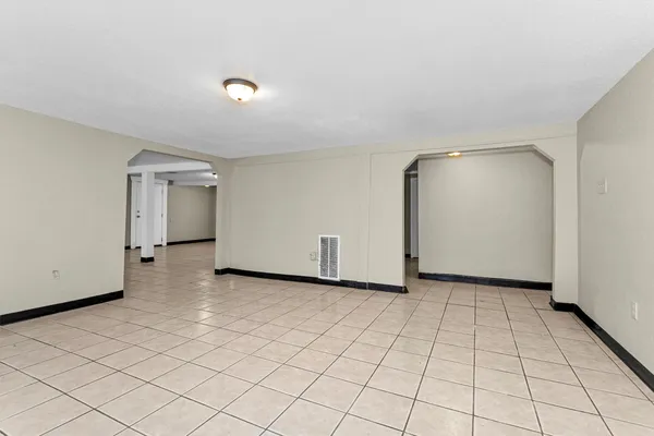 an empty room with windows and closet