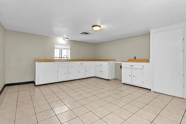 a view of a kitchen with white cabinets