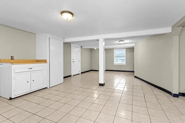a view of a kitchen with a sink and a refrigerator