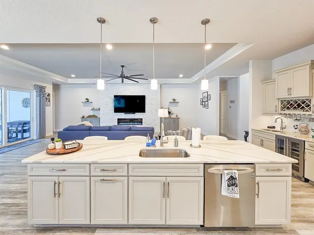 a dining room with furniture a chandelier and window