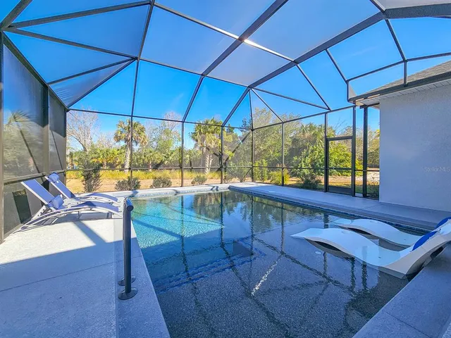 a living room with fireplace furniture and a large window