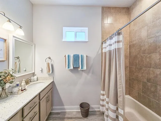 a bathroom with a double vanity sink and a mirror