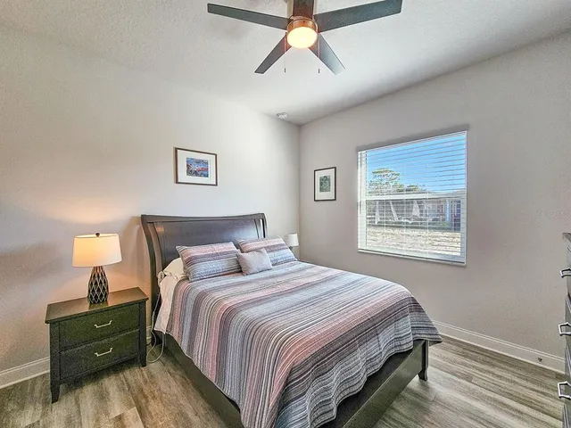 a bedroom with a bed and a painting on the wall