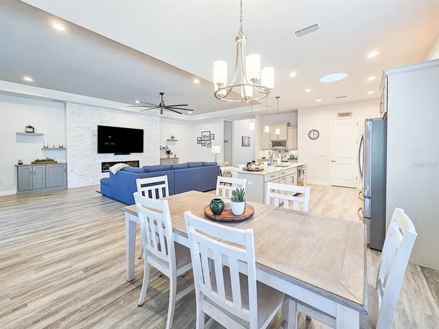 a kitchen with kitchen island granite countertop a sink dining table and chairs