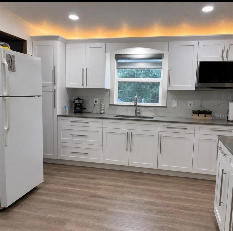 4 Eden Cemetery Road Frostproof, FL 33843 - Photo 6 of 15 a kitchen with stainless steel appliances a refrigerator sink and microwave