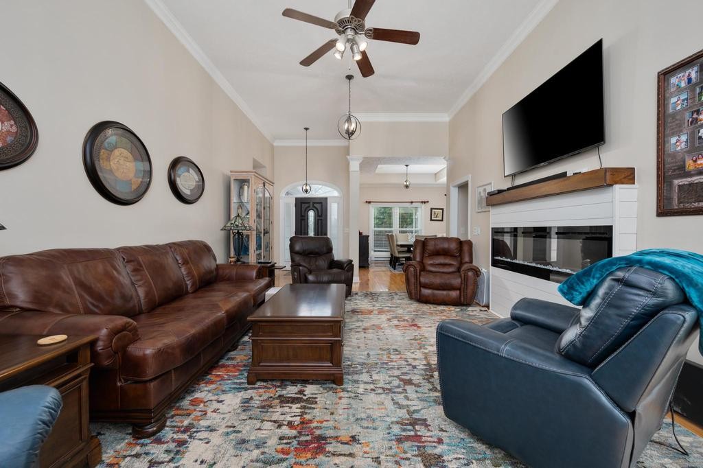 211 Oak Hollow Road Manchester, TN 37355 - Photo 7 of 31 a living room with furniture a flat screen tv and a fireplace