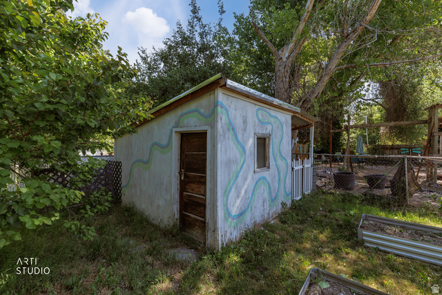 146 West 200 N Street Springville, UT 84663 - Photo 28 of 29 Detached shed with painted exterior, a wooden door, and a single window