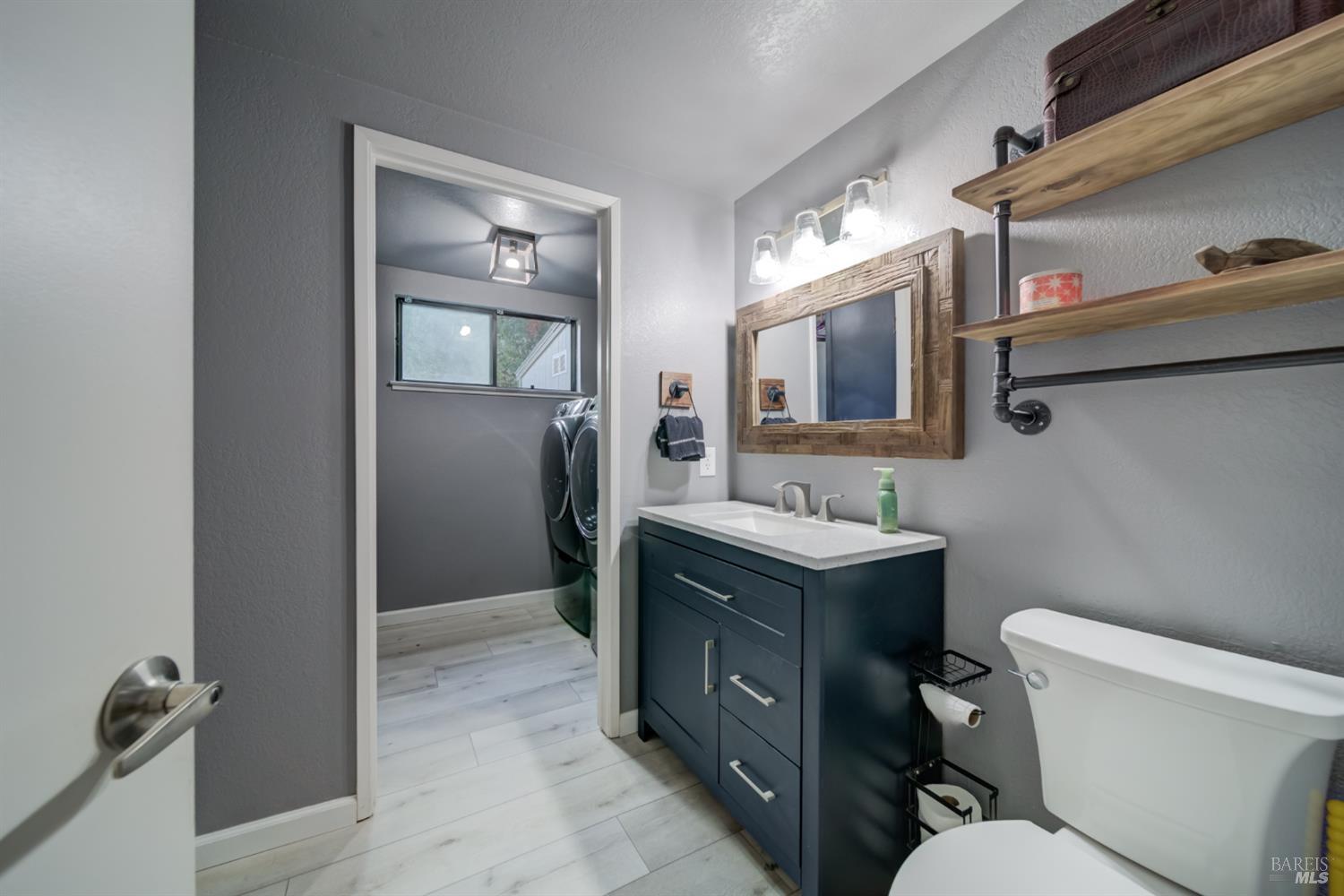 989 Suffolk Way Fairfield, CA 94533 - Photo 9 of 30 a bathroom with a toilet sink vanity tub and mirror