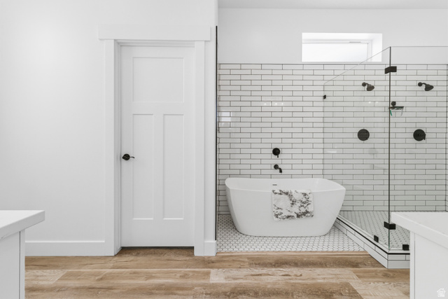 886 North 300th East Spring City, UT 84662 - Photo 26 of 40 Bathroom featuring vanity, tile walls, a stall shower, a freestanding bath, and light wood finished floors