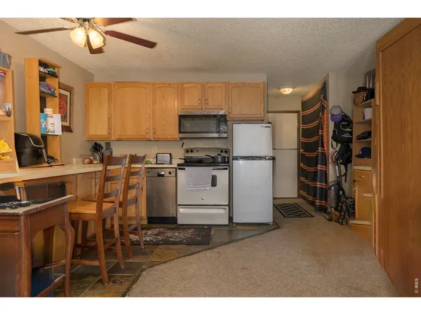 a kitchen with appliances cabinets and a counter top space