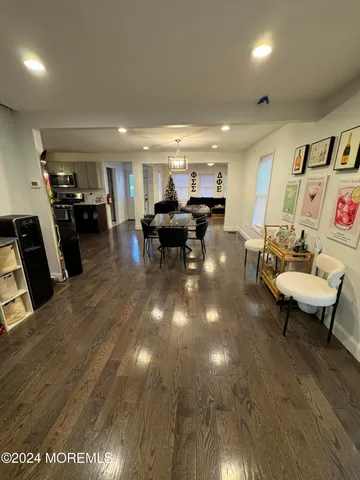 a view of a room with dining table chairs and a chandelier