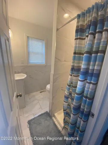 a view of bathroom with toilet and shower