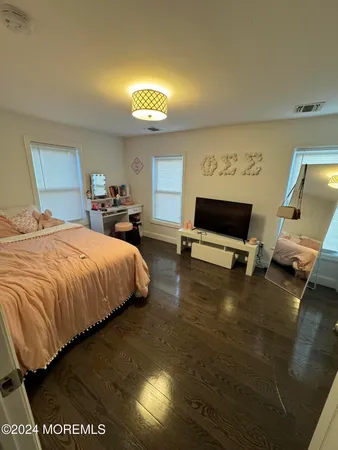 a bedroom with a bed and glass door
