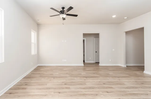 a view of an empty room with wooden floor