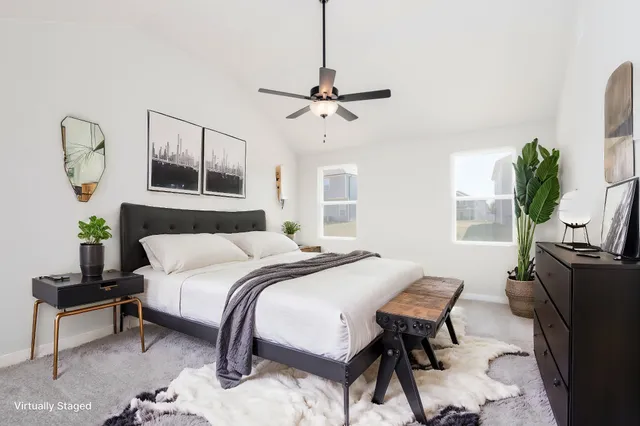 a bedroom with a bed a chandelier with a dresser and potted plants