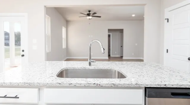 a bathroom with sink granite and bathtub