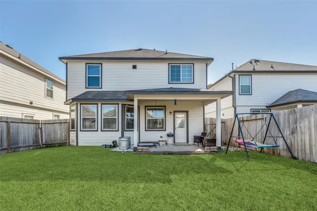 a view of a house with a backyard