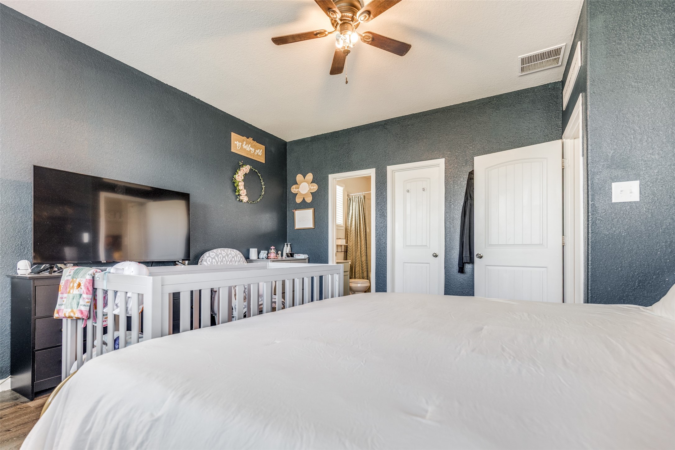 3633 Cub Drive Conroe, TX 77301 - Photo 7 of 30 a bedroom with three beds and a flat screen tv