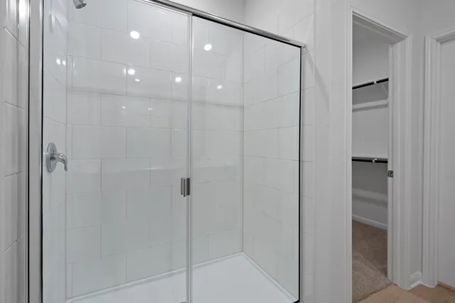 a bathroom with a shower and a glass door
