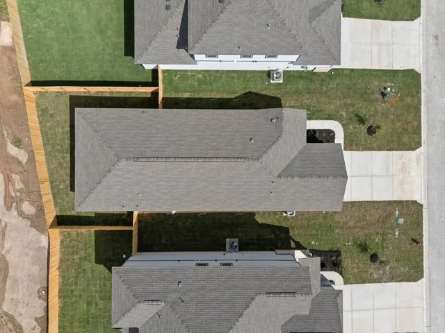 an aerial view of a house with a yard