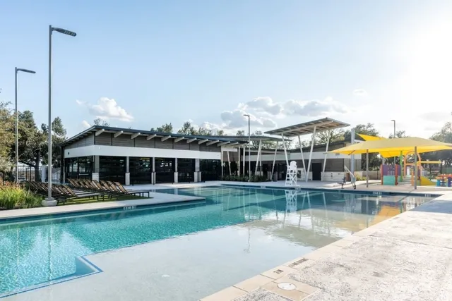 a view of a house next to a lake with houses