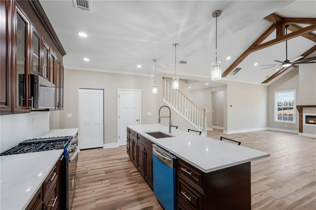 2322 Rockbridge Road Southwest Stone Mountain, GA 30087 - Photo 14 of 46 a kitchen with a sink a stove and a wooden floor