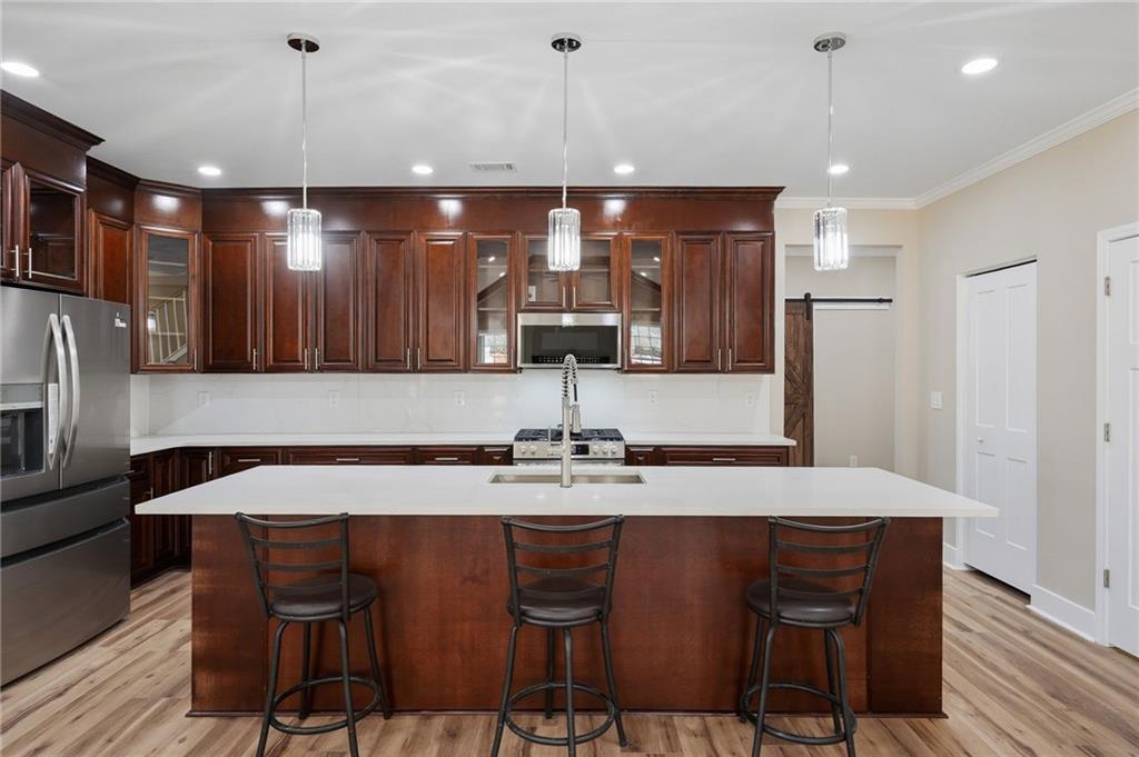 2322 Rockbridge Road Southwest Stone Mountain, GA 30087 - Photo 18 of 46 a kitchen with a table chairs refrigerator and microwave