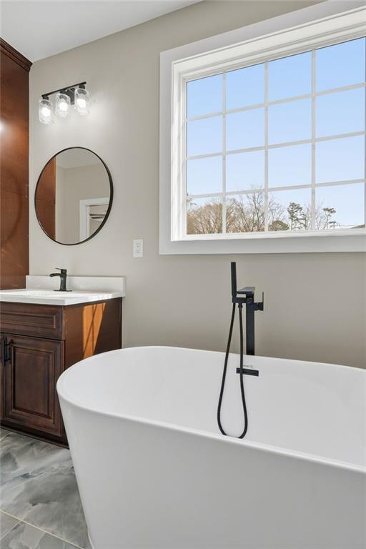 2322 Rockbridge Road Southwest Stone Mountain, GA 30087 - Photo 26 of 46 a bathroom with a sink and a mirror