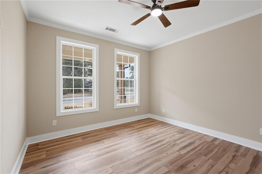 2322 Rockbridge Road Southwest Stone Mountain, GA 30087 - Photo 28 of 46 a view of a livingroom with wooden floor and windows
