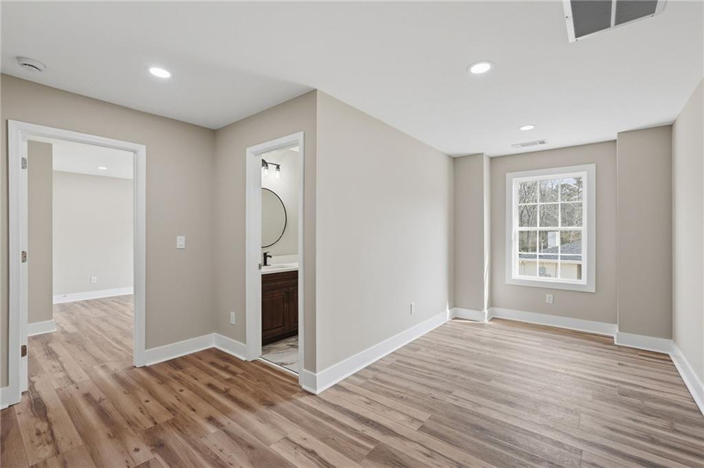 2322 Rockbridge Road Southwest Stone Mountain, GA 30087 - Photo 32 of 46 a view of an empty room with wooden floor and a window