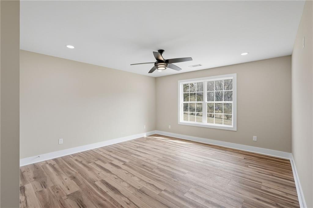 2322 Rockbridge Road Southwest Stone Mountain, GA 30087 - Photo 34 of 46 wooden floor in an empty room with a window