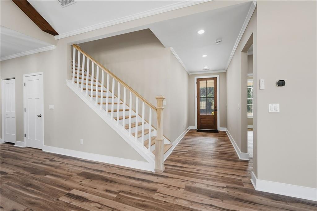 2322 Rockbridge Road Southwest Stone Mountain, GA 30087 - Photo 4 of 46 a view of a hallway with wooden floor and stairs