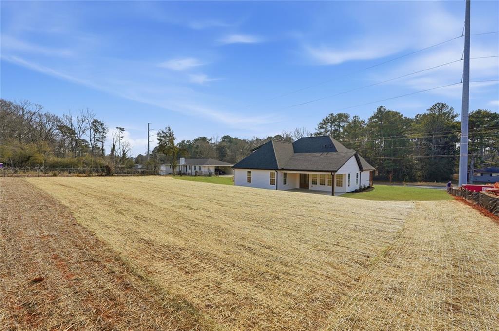 2322 Rockbridge Road Southwest Stone Mountain, GA 30087 - Photo 45 of 46 a view of a house with a yard and a large tree