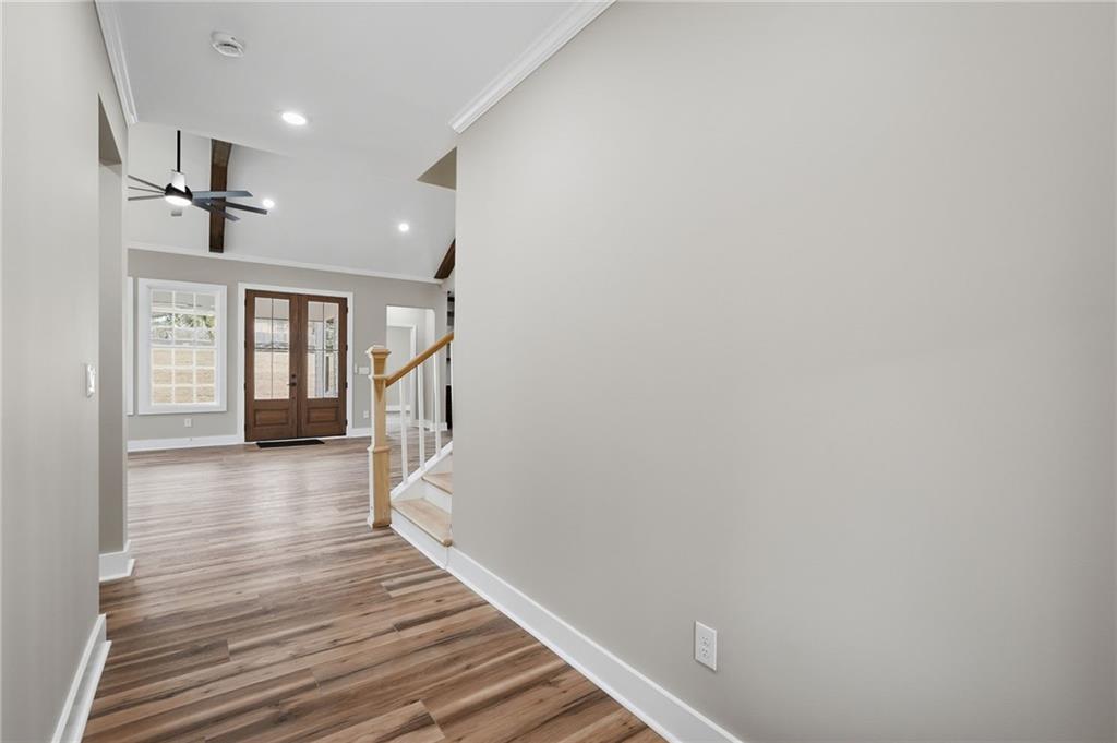 2322 Rockbridge Road Southwest Stone Mountain, GA 30087 - Photo 5 of 46 a hallway with wooden floor windows and a kitchen
