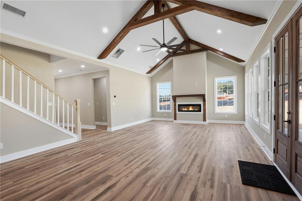 2322 Rockbridge Road Southwest Stone Mountain, GA 30087 - Photo 7 of 46 a view of an empty room with wooden floor fireplace and a window