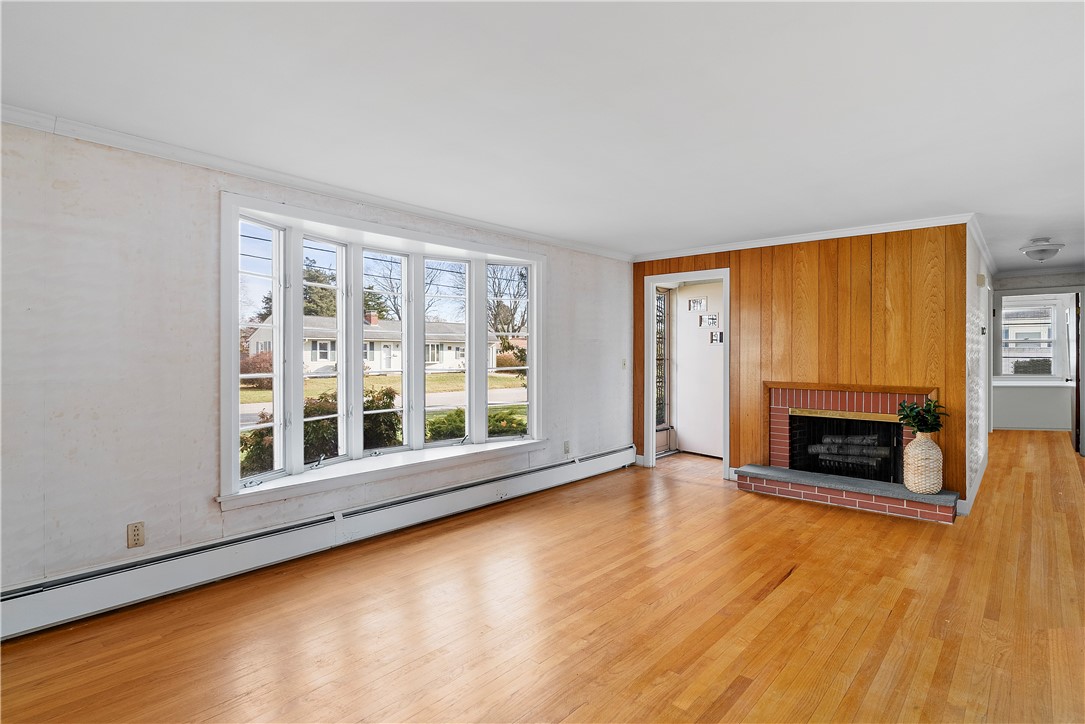 15 Killdeer Road Warwick, RI 02888 - Photo 3 of 29 Living room with hardwood floors and wood burning fireplace