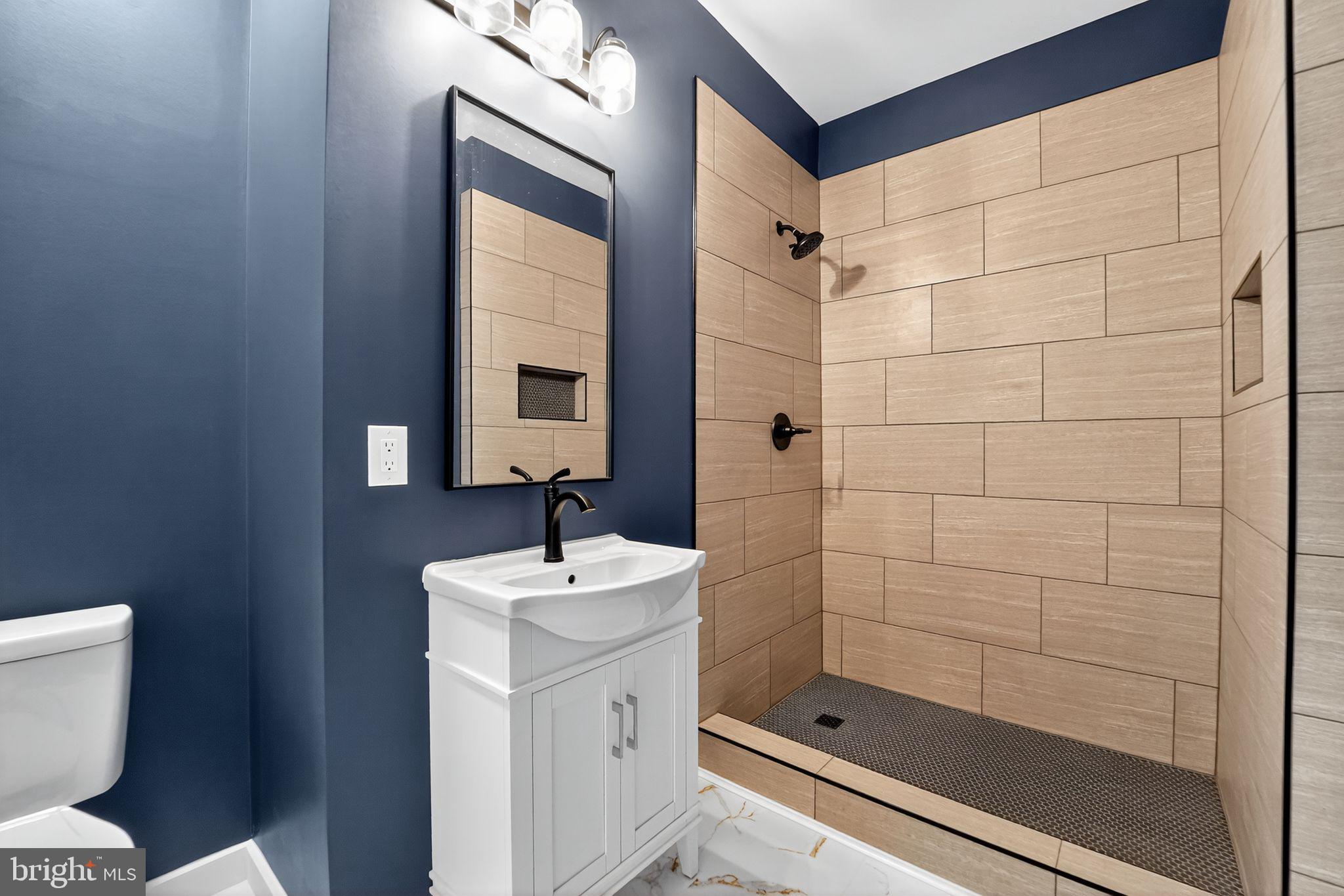 8305 Biggs Ford Road Walkersville, MD 21793 - Photo 13 of 38 a bathroom with a shower a toilet and sink