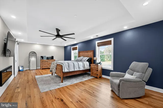 a bed sitting in a spacious bedroom next to a window