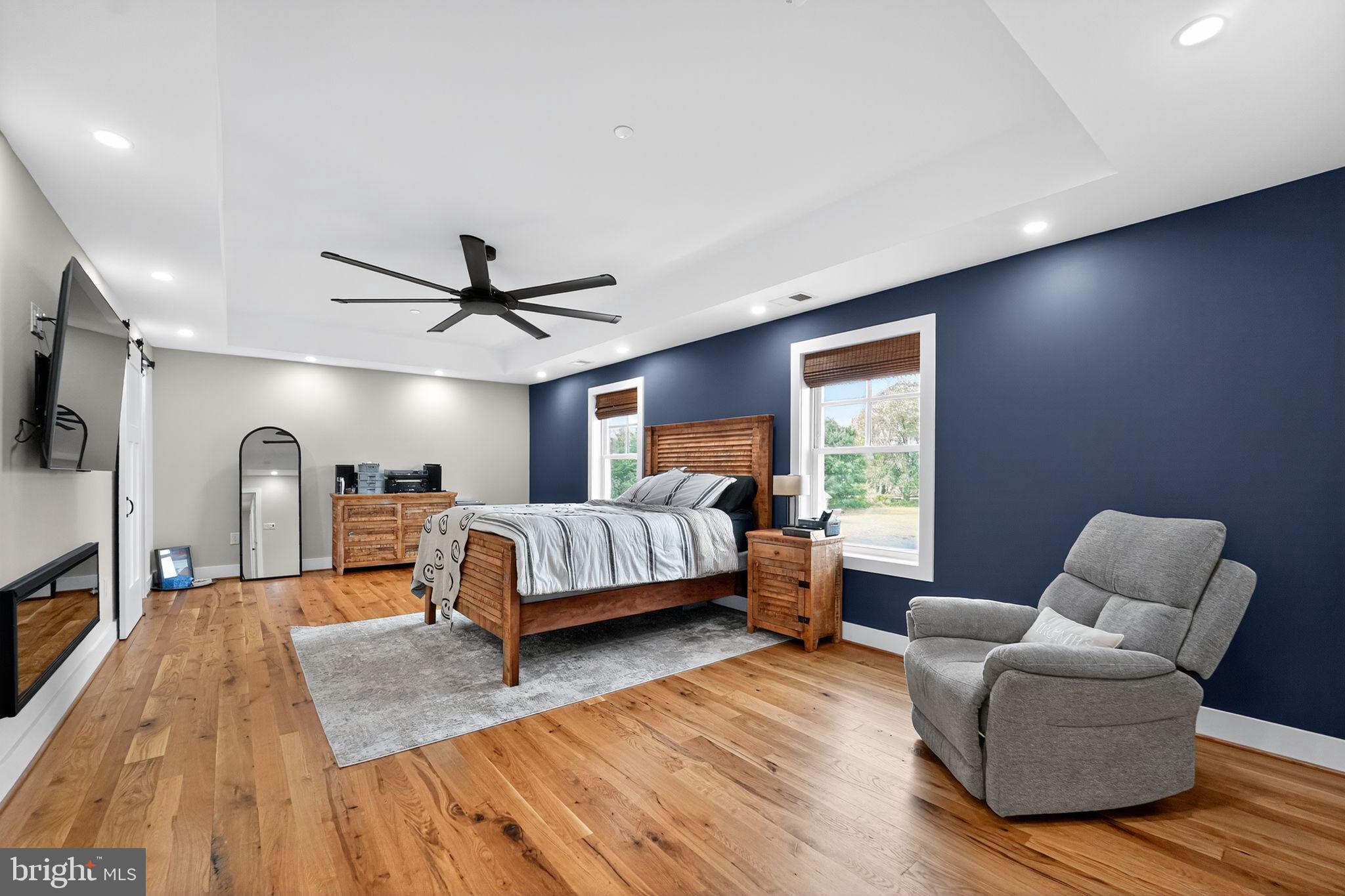 8305 Biggs Ford Road Walkersville, MD 21793 - Photo 16 of 38 a bedroom with furniture and a wooden floor