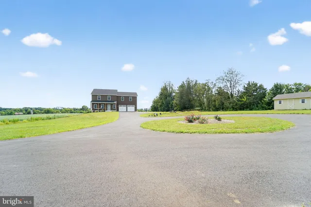 a view of a house with a swimming pool and a yard