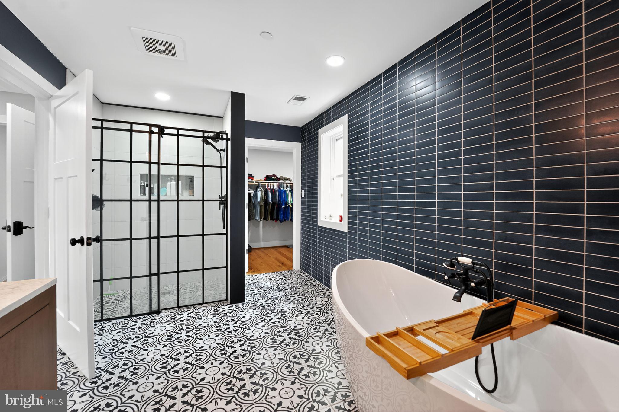 8305 Biggs Ford Road Walkersville, MD 21793 - Photo 21 of 38 a bathroom with granite countertop shower a sink and a mirror