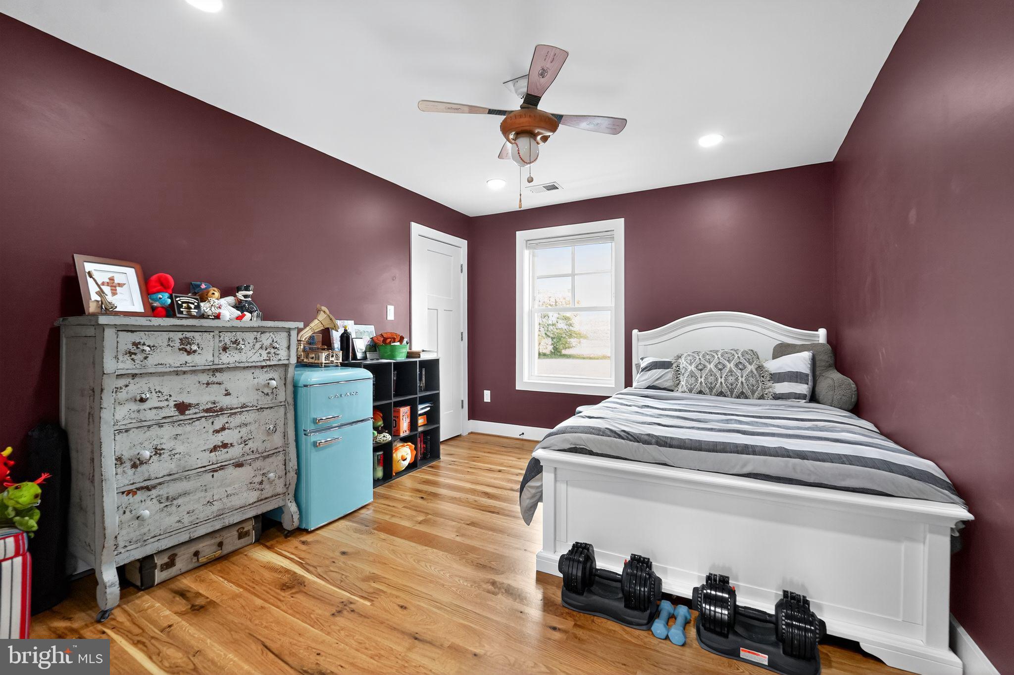 8305 Biggs Ford Road Walkersville, MD 21793 - Photo 23 of 38 a bedroom with a bed and a chandelier