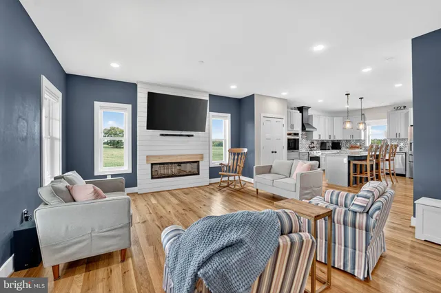 a living room with fireplace furniture and a flat screen tv