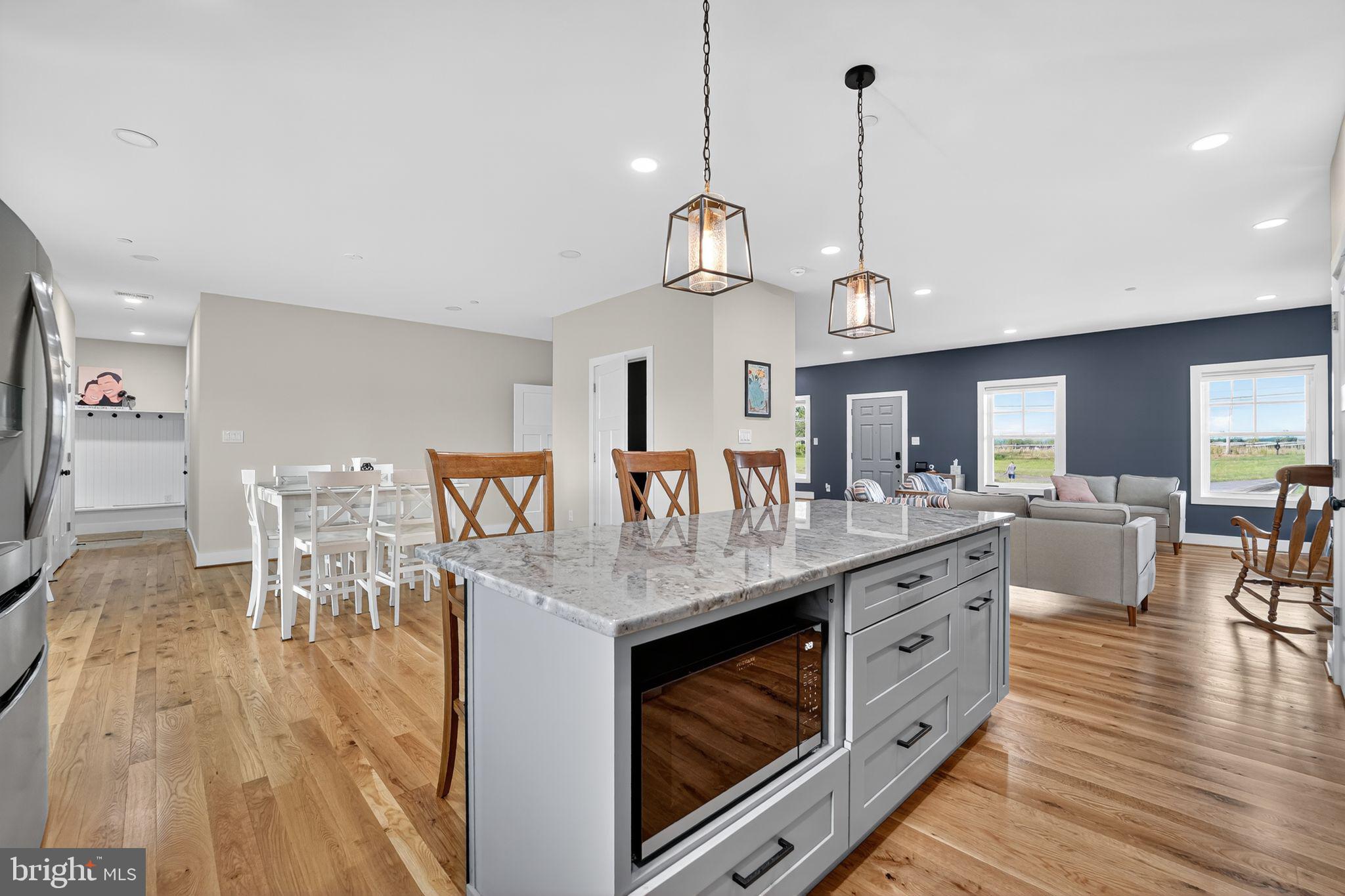8305 Biggs Ford Road Walkersville, MD 21793 - Photo 7 of 38 a view of a dining room and livingroom with furniture wooden floor a chandelier