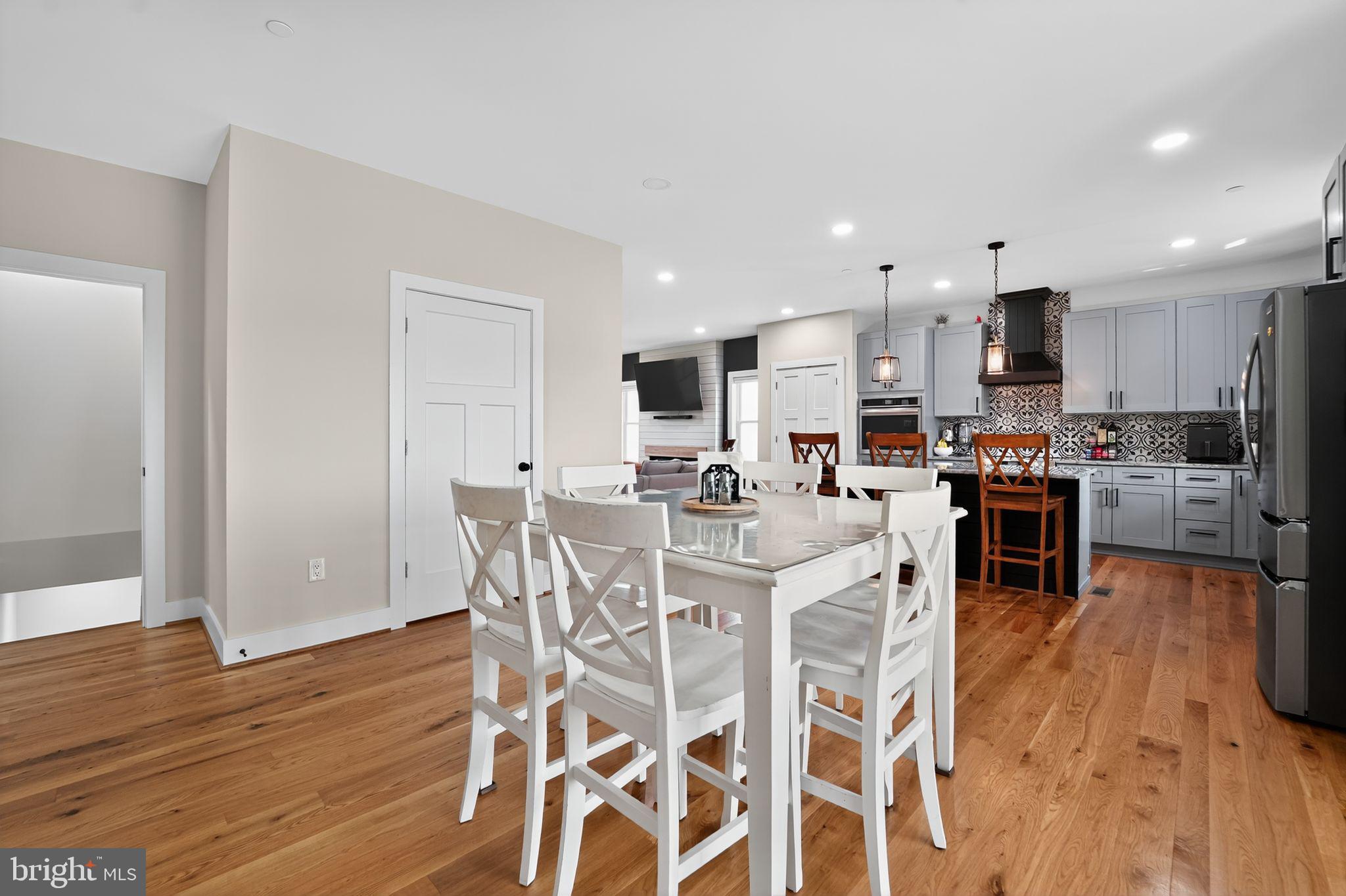 8305 Biggs Ford Road Walkersville, MD 21793 - Photo 9 of 38 a living room with stainless steel appliances kitchen island granite countertop furniture and wooden floor
