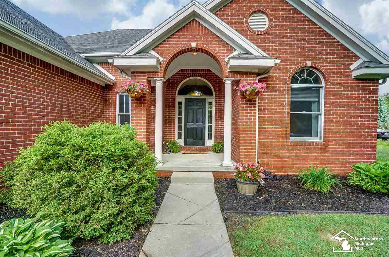 6475 Douglas Road Lambertville, MI 48144 - Photo 3 of 39 Sidewalk from driveway leads up to covered front porch and manicured landscape.